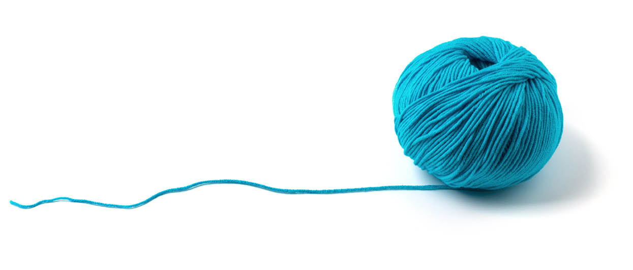 Ball of yarn on white background