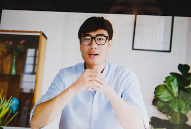 Asia businesswoman using laptop talk to colleagues about plan in video call meeting while working from home at living room  Self-isolation, social distancing, quarantine for corona virus prevention 